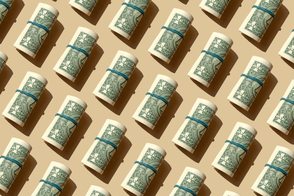 Roll of American dollars banknotes on the beige background