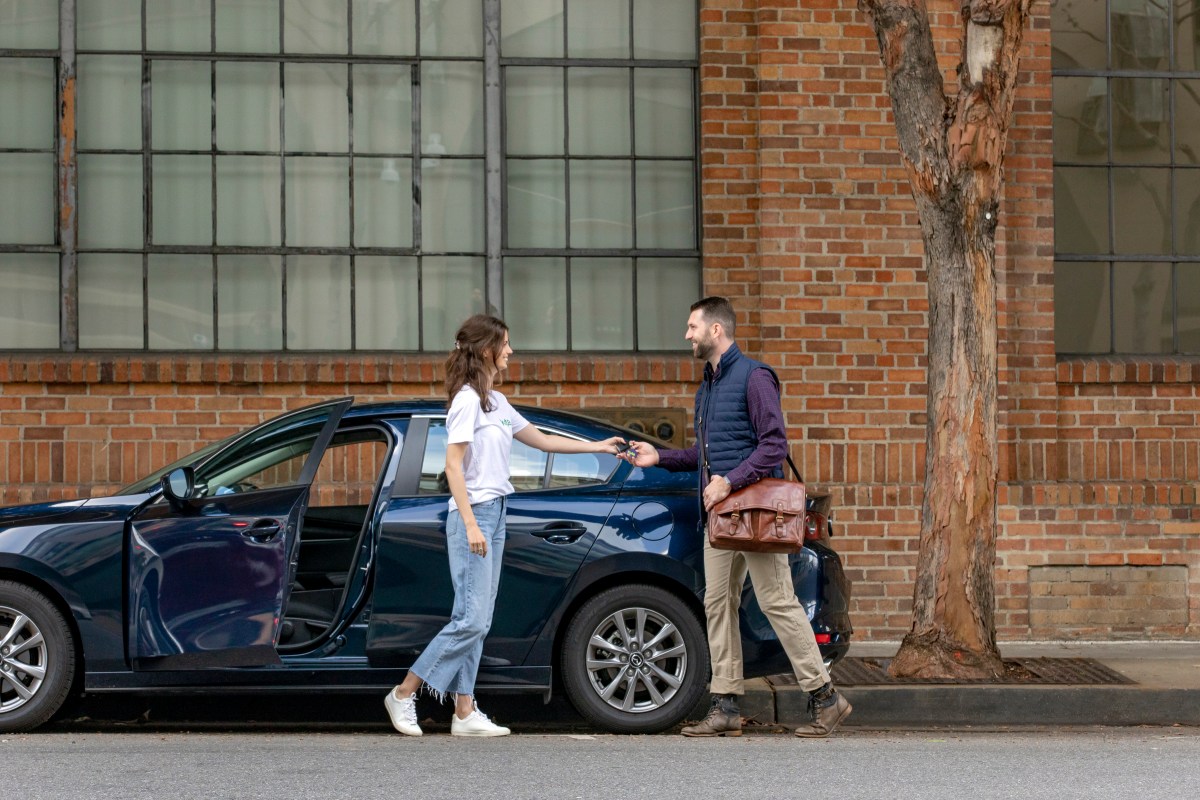 Woman gets keys to rental car from man