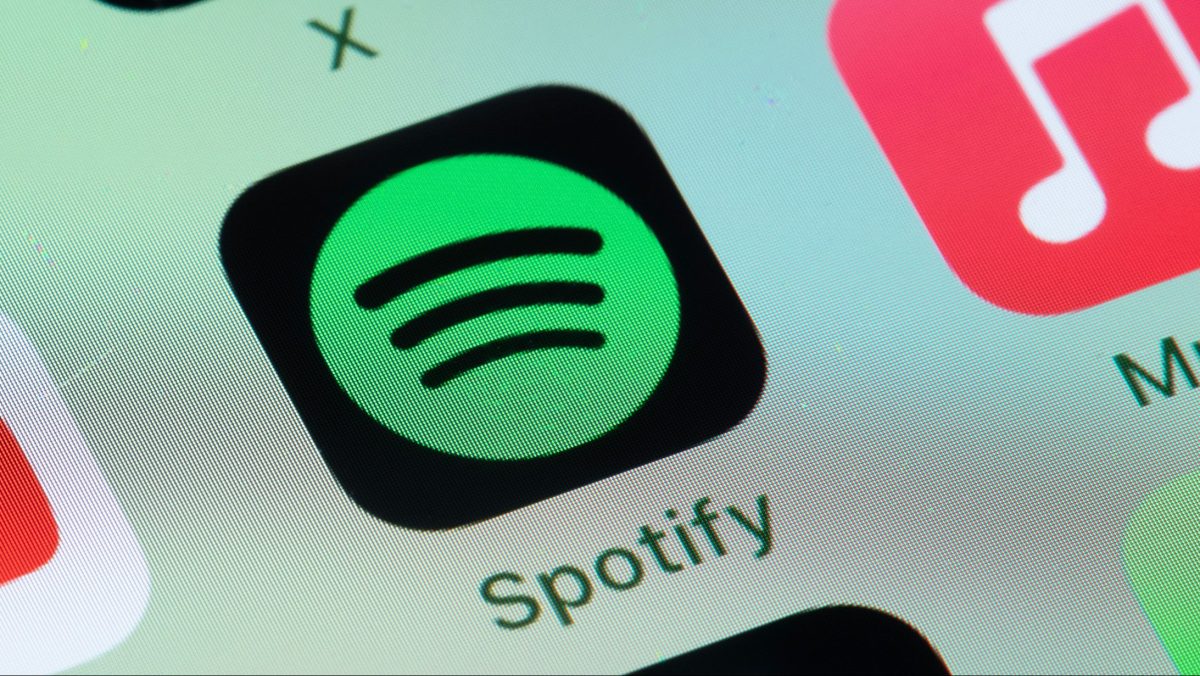 Spotify, Apple Music on smart phone screen.