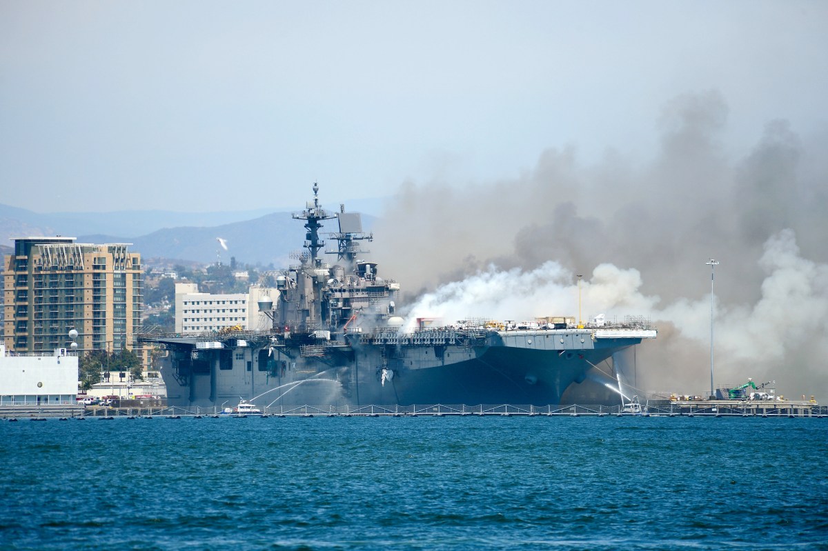 Port of San Diego Harbor Police Department boats combat a fire aboard the amphibious assault ship USS Bonhomme Richard (LHD 6) at Naval Base San Diego.