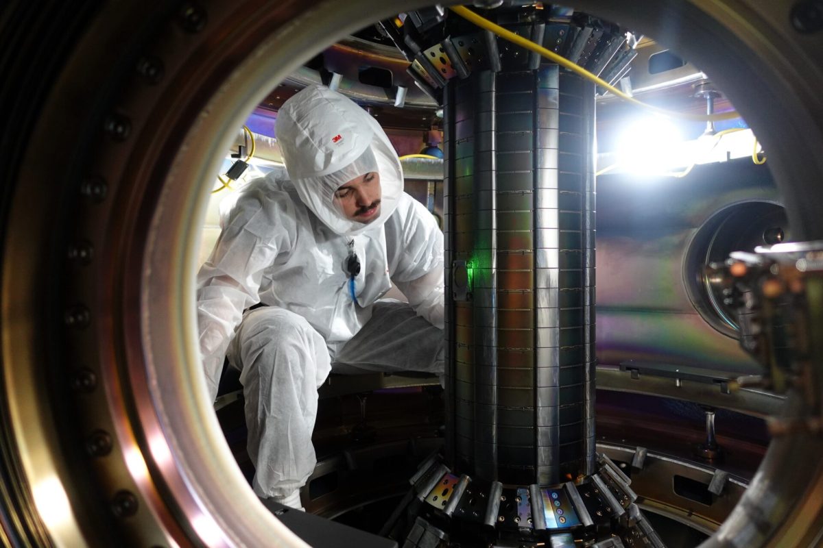 A technician works inside Tokamak Energy's prototype reactor.